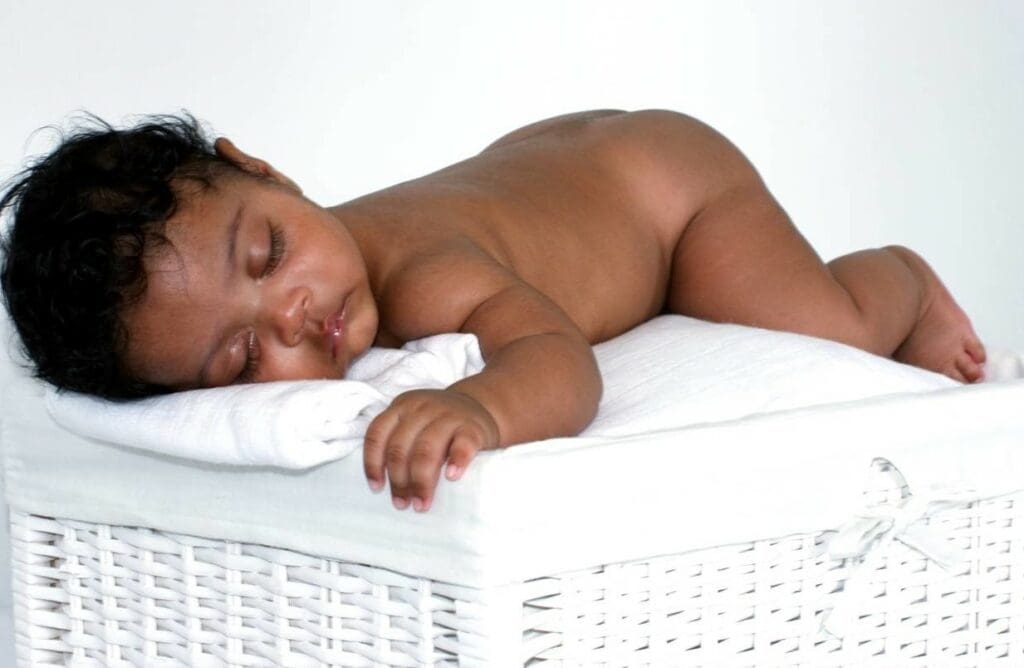 baby sleeping black breastfeeding week