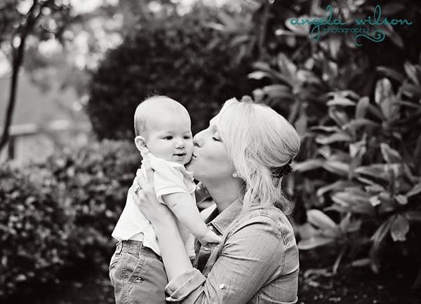 A Mother Kissing Her Baby on Cheek Black and White Image