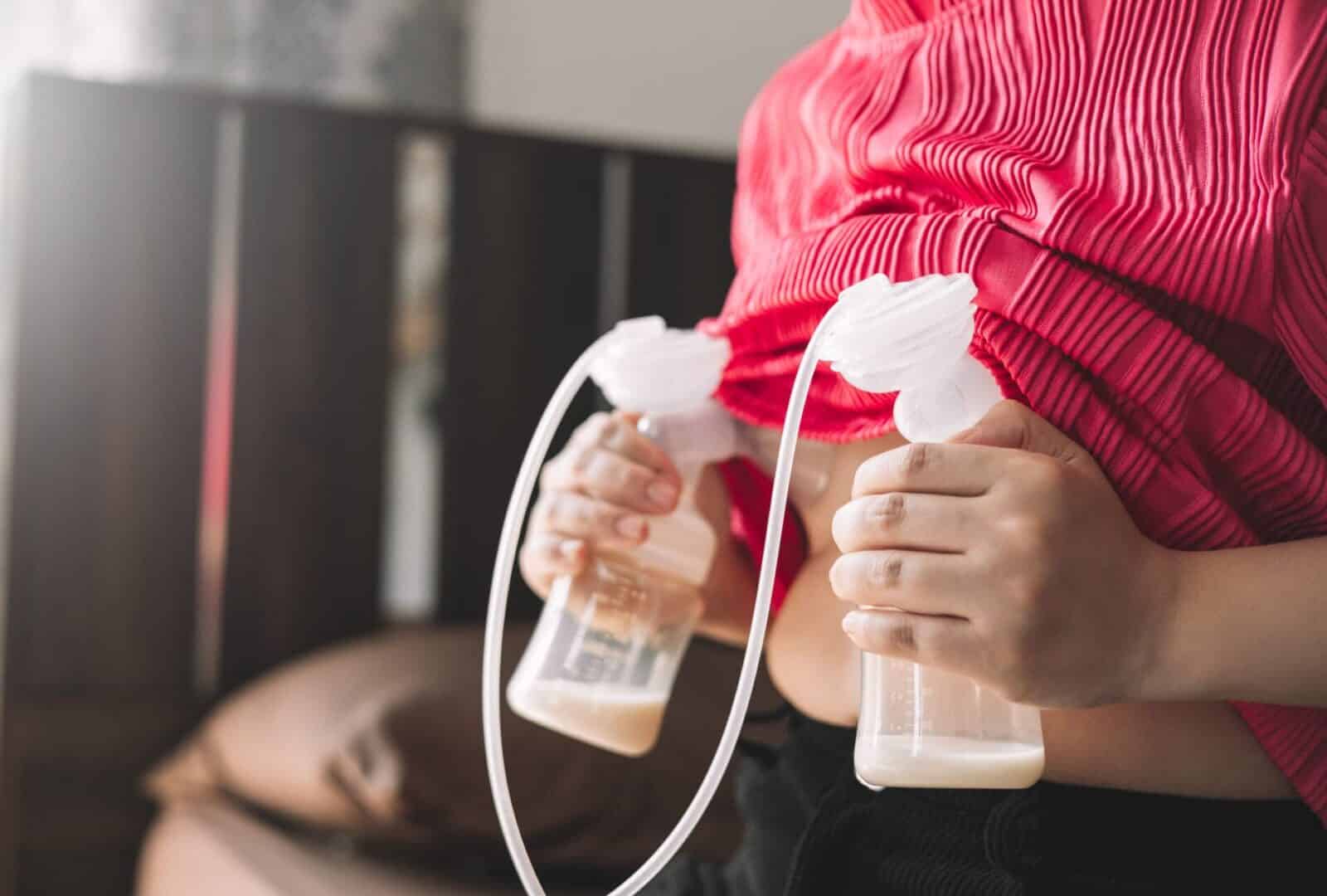 A mother expressing milk with an electric breast pump during an exclusive pumping session.