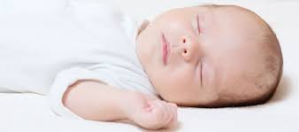 A newborn sleeping swaddled.