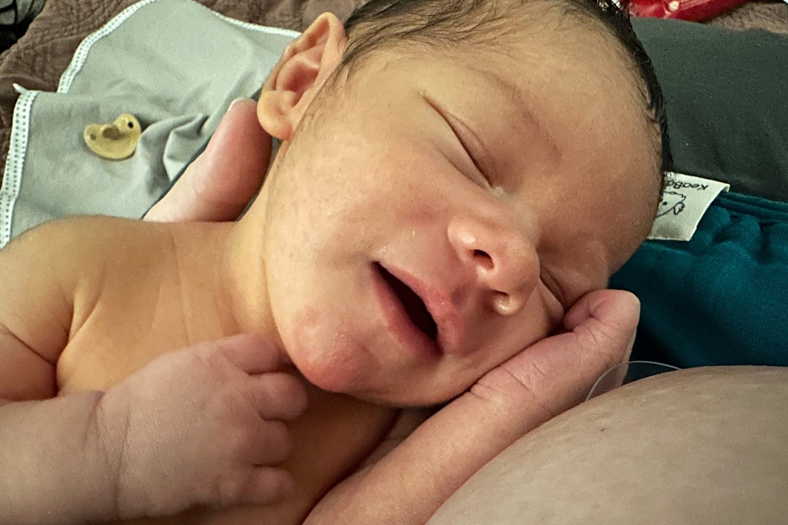 A relaxed, milk-drunk newborn resting after breastfeeding, content and satisfied.