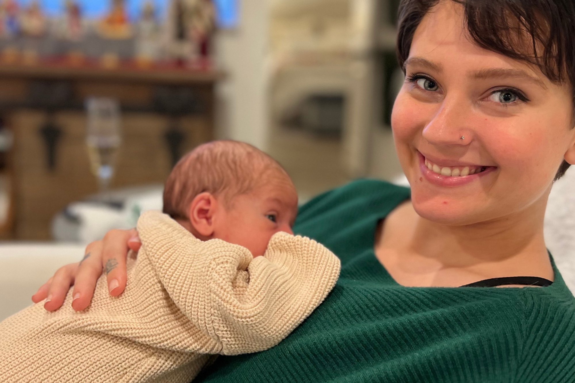 A parent holding their newborn close