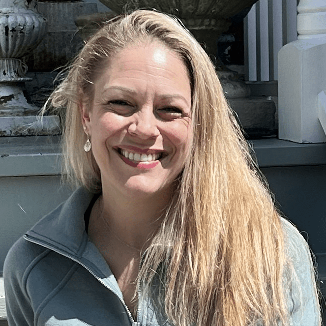 Woman smiling in a blue jacket.