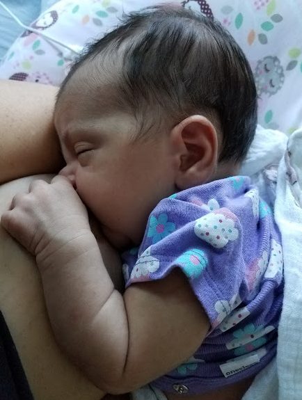 A toddler resting against a soft blanket.