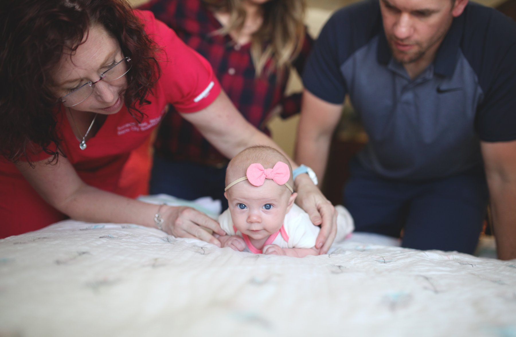 Suzanne Juel, IBCLC, working with a baby and family during a home visit